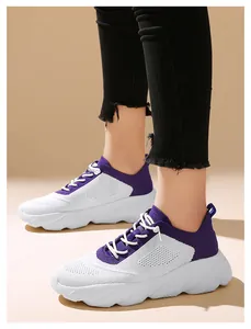 Side view of lightweight purple and white fly-knit sneakers worn with black jeans.