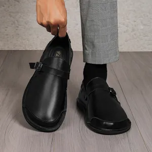 Detail of men's retro wide-toe leather shoes with adjustable strap and buckle closure.