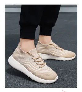 Men's lightweight breathable knit casual sneakers shown on feet during outdoor wear.