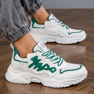Detailed shot of stylish white and green chunky men's sneakers on a dark wooden floor