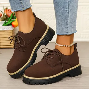 Classic dark brown suede lace-up Oxford shoes for women featuring thick black lug soles