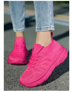 Close-up detail view of pink lightweight knitted sneakers with thick soles and breathable fabric