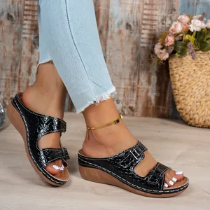 Elegant black crocodile-pattern wedge sandals with double buckle straps and platform sole
