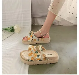 Detail view of women's platform sandals featuring cute pineapple print and dual-wear straps.