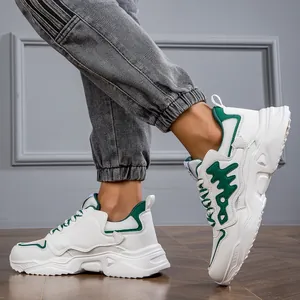 Close-up of white and green chunky sneakers for men featuring fashion thick soles