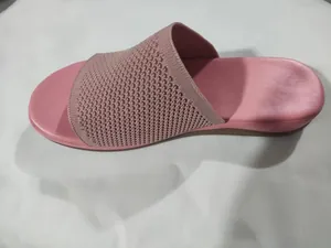 Detailed side view of pink knitted flat canvas slide sandal with comfortable sole