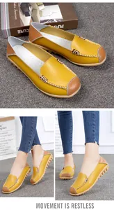 Yellow leather casual loafers for women with cross-stitching detail shown on model
