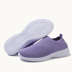 Detailed view of purple fly-knit sock shoes with white slip-resistant sole