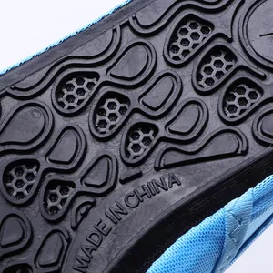 Macro detail of the durable anti-slip rubber sole on blue beach and swimming water shoes