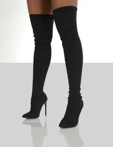 Detailed view of black knitted over-the-knee boots with high stiletto heels