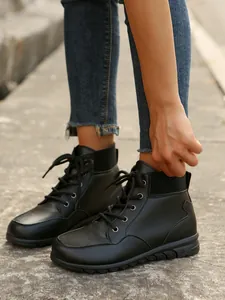 Detail view of black British style lace-up ankle boots featuring a ribbed collar design