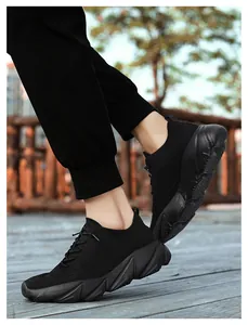 Detailed side view of lightweight black fly-knit sneakers for walking and casual wear