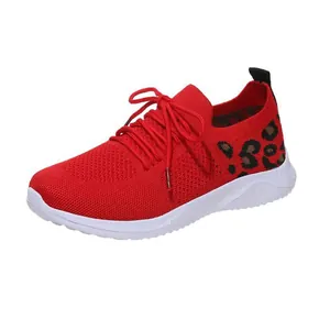 Detailed side view of red mesh sports sneaker featuring stylish leopard print heel detail