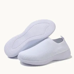 Detail view of lightweight white knit slip-on sneakers showing soft non-slip sole texture