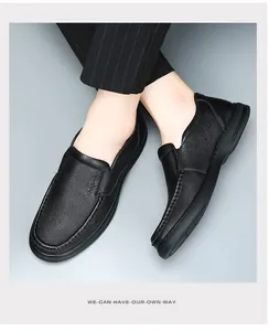 Macro detail of premium men's black leather loafers featuring breathable texture.