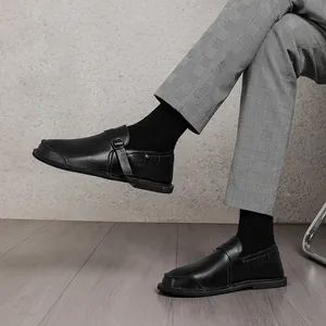 Detailed side view of black wide-toe retro leather shoes for men worn with plaid pants