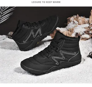 Detail of black insulated snow boots with warm faux fur lining on a snowy background.