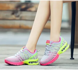 Grey and pink women's mesh running shoes with neon green accents and an air cushion sole