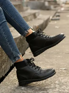 Detail view of women's black British style lace-up ankle boots with platform sole
