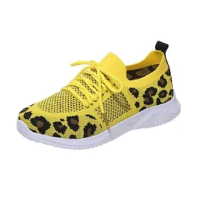 Detailed view of yellow mesh women's sneakers featuring a bold leopard print design
