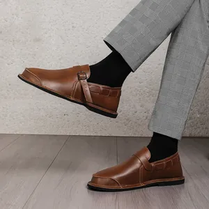 Detailed shot of vintage brown wide-toe leather shoes for men featuring buckle straps