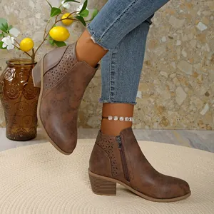 Vintage brown women's Chelsea boots featuring elegant hollow-out pattern and low block heel