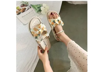 A detailed view showing the cute pineapple print and bow on these women's platform sandals