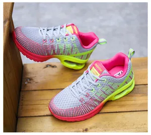 Detail of women's grey and pink mesh running shoes with lime green air cushion sole