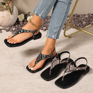 Detailed view of women's flat flip-flop sandals featuring trendy snake print patterns.