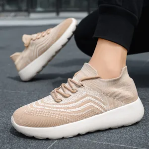 Men's lightweight breathable knit running shoes in tan with white sole outdoor shot