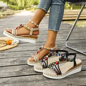 Detailed macro view of bohemian wedge sandals featuring colorful beads and woven straps