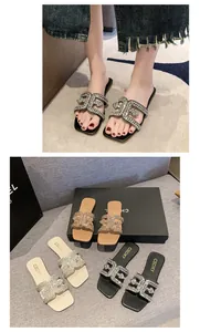Close-up of sparkling rhinestone interlocking pattern on stylish square-toe flat slippers.