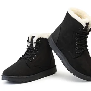 Close-up of black lace-up winter boots with thick white faux fur lining for warmth.