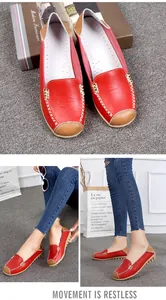 Detailed views of red leather loafers for women featuring stitching and gold buckle decor.