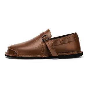 Side view of vintage brown leather men's shoe with wide toe box and buckle strap