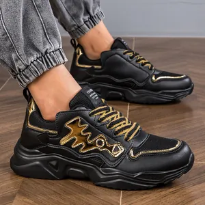 Close-up detail of stylish men's black and gold chunky sneakers with a durable thick sole.