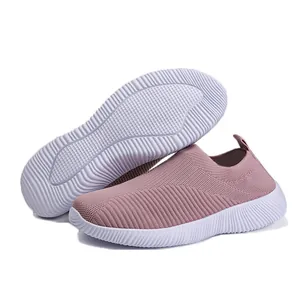 Detailed view of mauve flyknit slip-on sneakers featuring breathable mesh and white soles