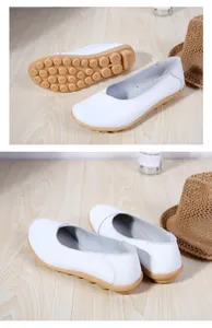 Close-up detail of white leather women's loafers showing soft gum rubber bean soles