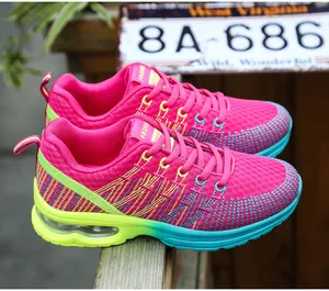 Macro view of women's pink mesh running shoes with neon green gradient air cushion sole