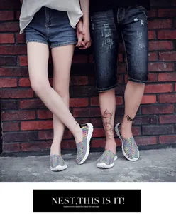 Detail view of couple wearing breathable grey and multi-color woven slip-on sneakers