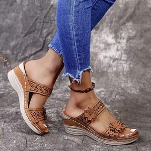 Detailed view of women's wedge sandals with flower and rhinestone embellishments