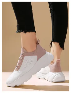 Side detail view of lightweight pink and white flying knit running sneakers for women