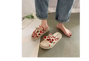Close-up of trendy strawberry print platform sandals for women in a lifestyle setting