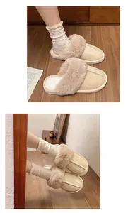 Close-up detail of beige fleece-lined furry slippers worn with white dotted socks on wood floor