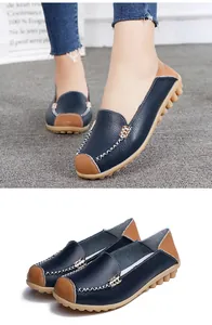 Close-up of navy blue and tan women's casual loafers with hand-stitched detailing.