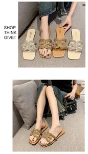 Detailed view of women wearing rhinestone flat slippers in a cozy lifestyle setting.