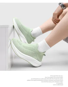 Detailed view of light green fly-knit sock sneakers highlighting the breathable mesh texture