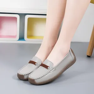 Comfortable grey leather women's loafers with soft flat sole and decorative brown strap