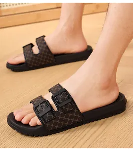 Detailed side view of men's double buckle slides with textured patterned straps