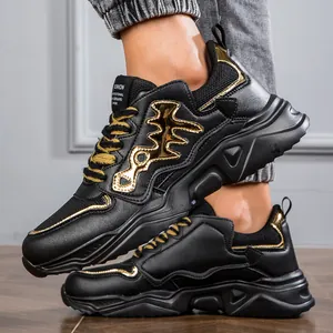 Detailed side view of black men's chunky sneakers with metallic gold accents.